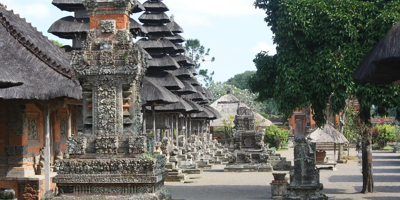 Stone shrines and tiered roofs in the inner temple at Taman Ayun, Bali