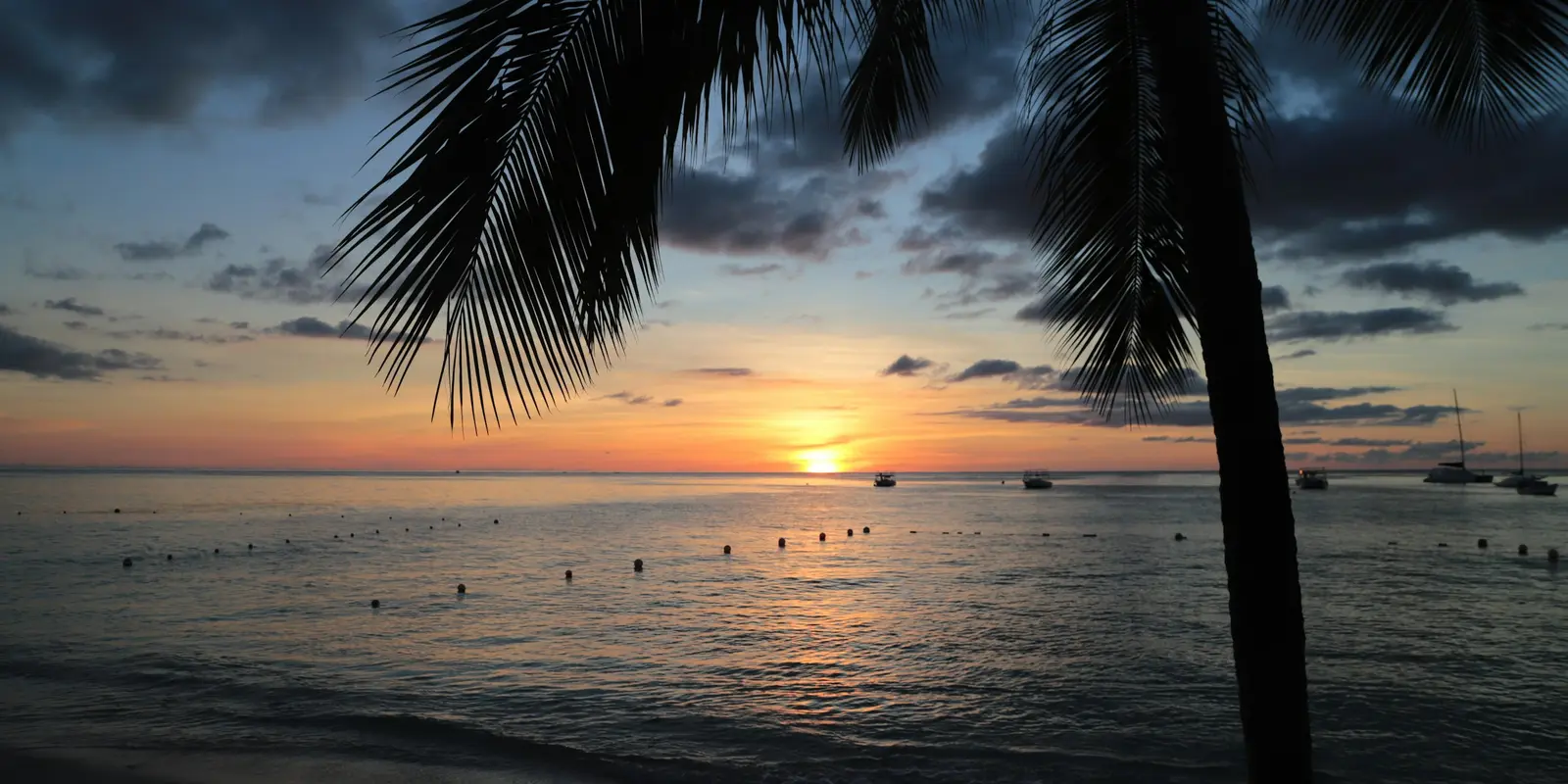 Holetown on Barbados' west coast — coverage on both Flow and Digicel is strongest along the island's developed coastlines Sunset over the ocean with boats near Holetown, Barbados