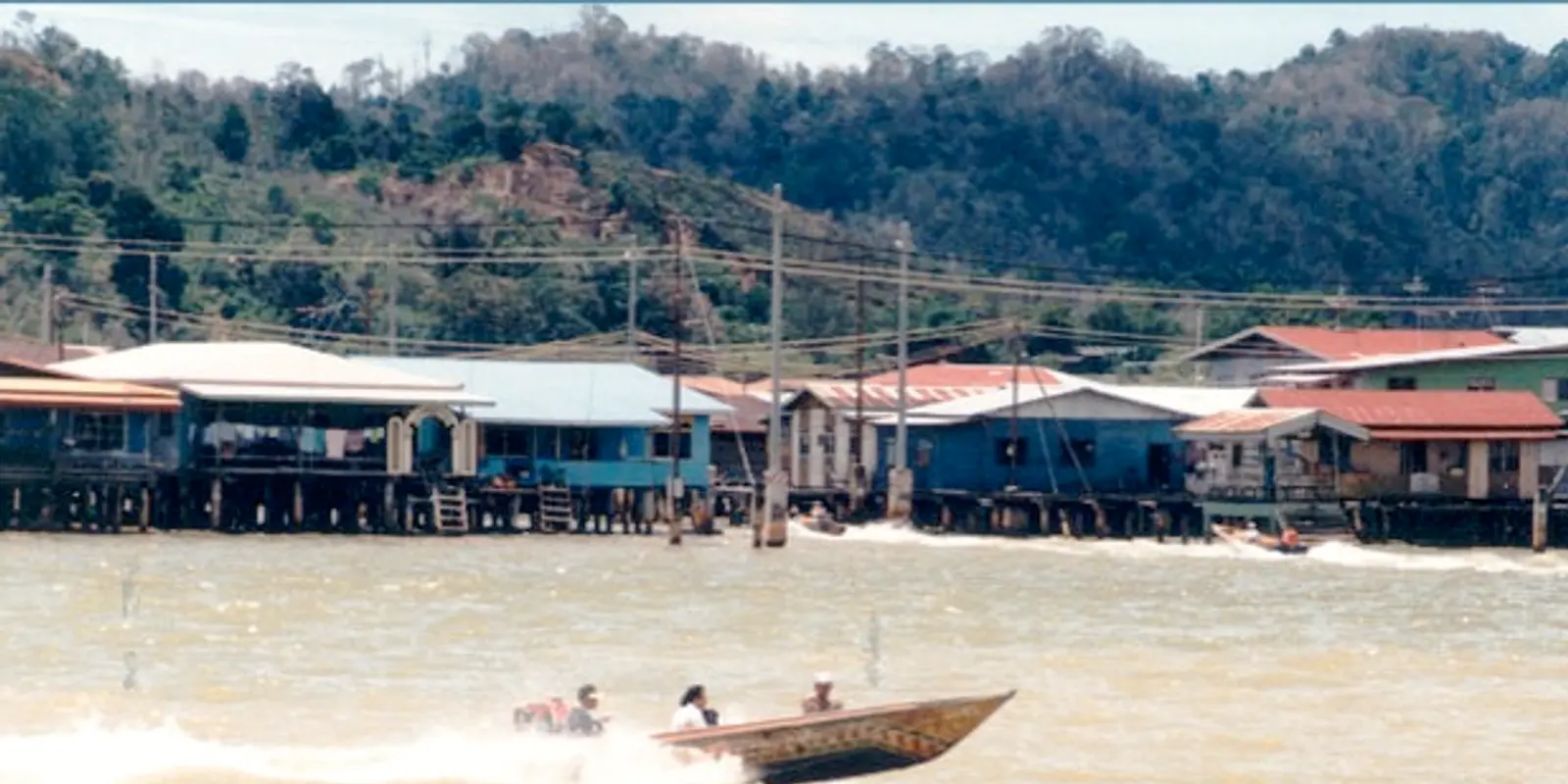 River travel needs offline preparation even with a mobile plan Boats and homes along a Brunei waterway