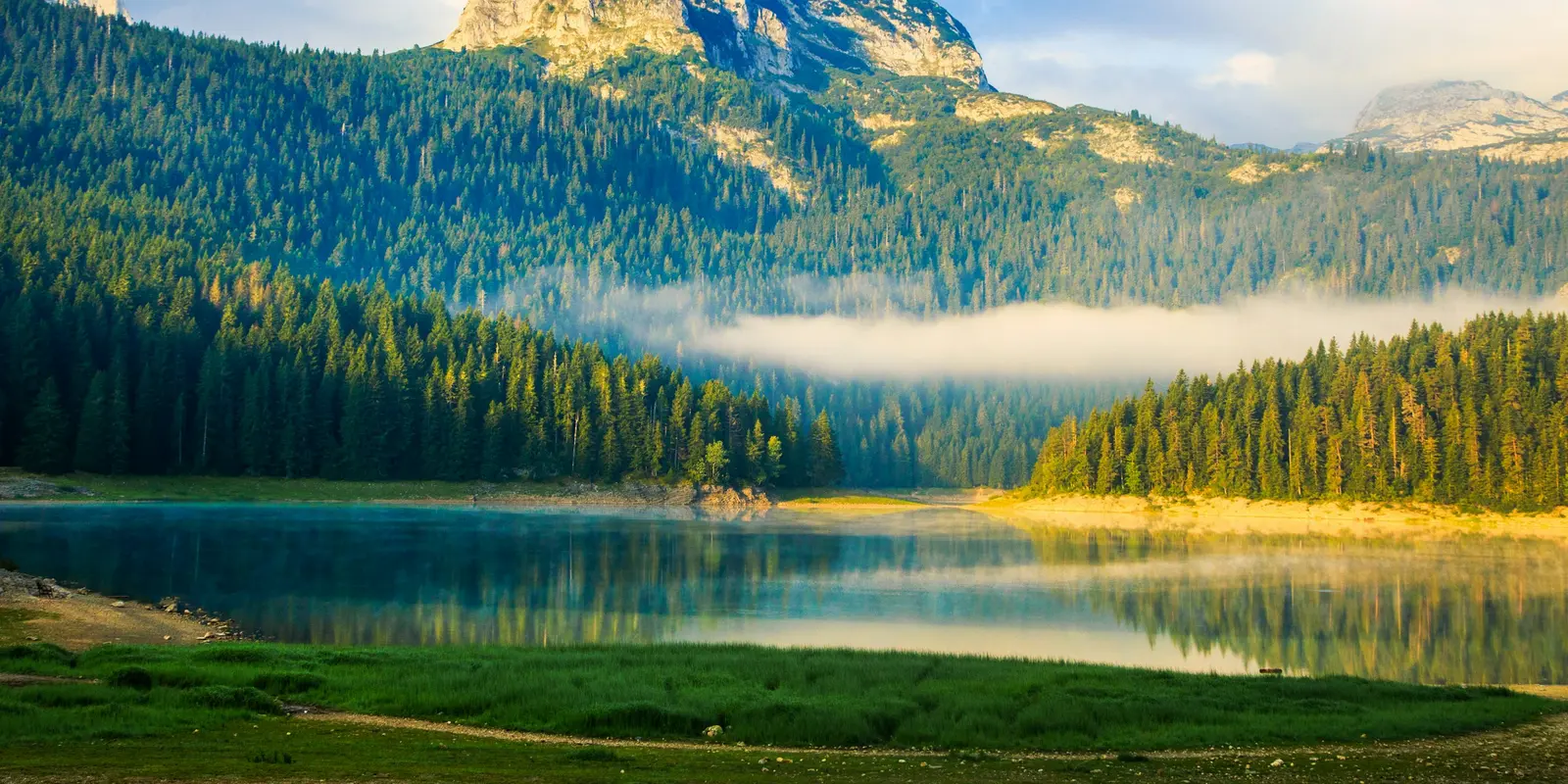 Morning mist over Black Lake in Durmitor National Park, Montenegro's mountain interior