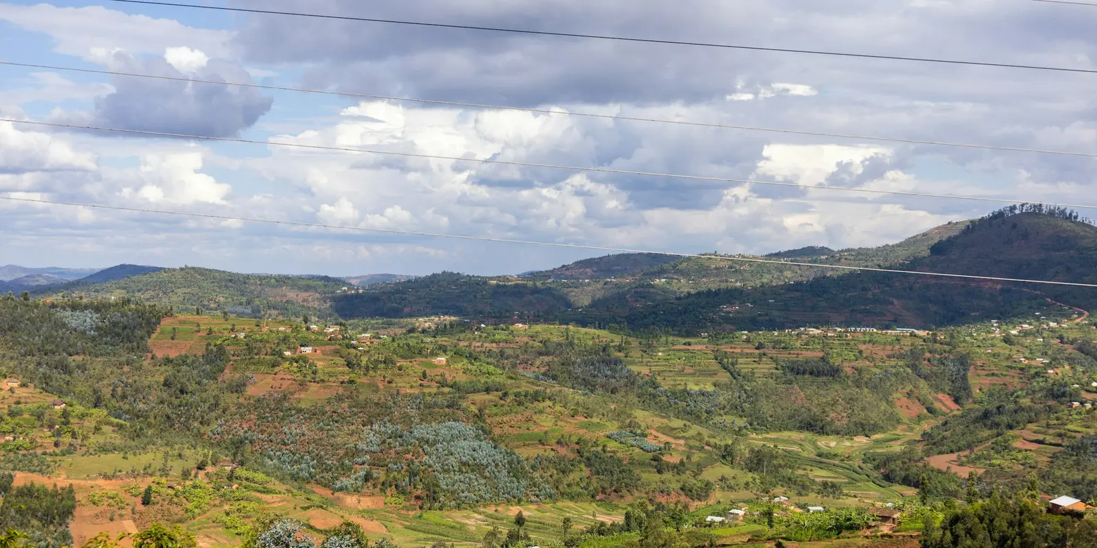Rwanda's highlands rise quickly outside the gateway towns Scenic Rwandan valley with trees and hills