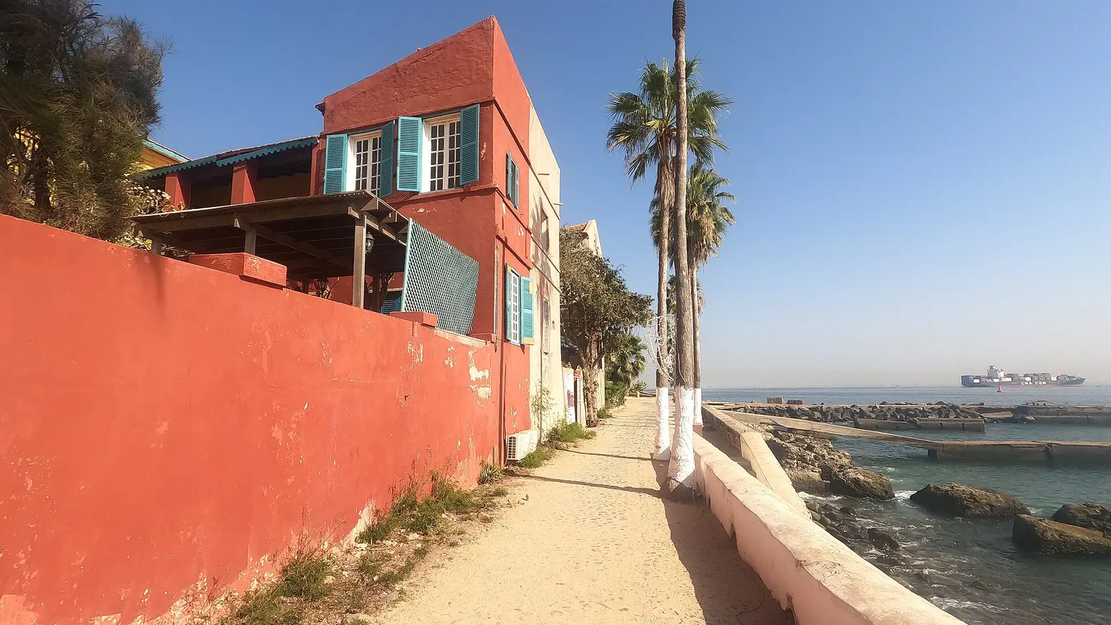 Save ferry details and directions before moving between Dakar and Gorée Street and waterfront on Gorée Island near Dakar