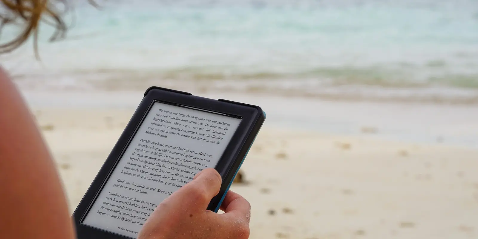 Person holding a tablet outdoors while traveling