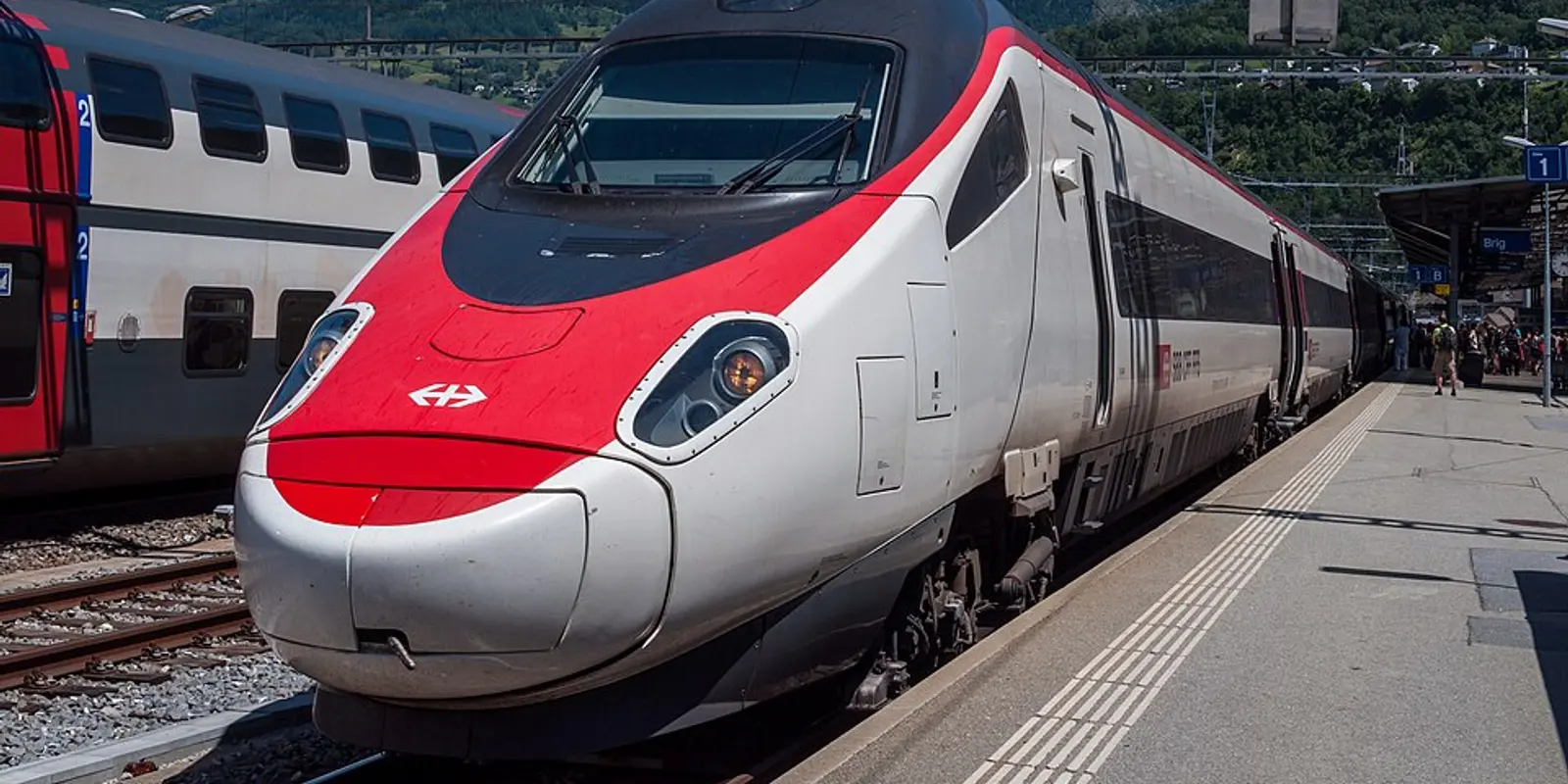 EuroCity at Brig, Switzerland; photo: Chme82, CC BY-SA 4.0 EuroCity train at Brig station on the Alpine rail corridor