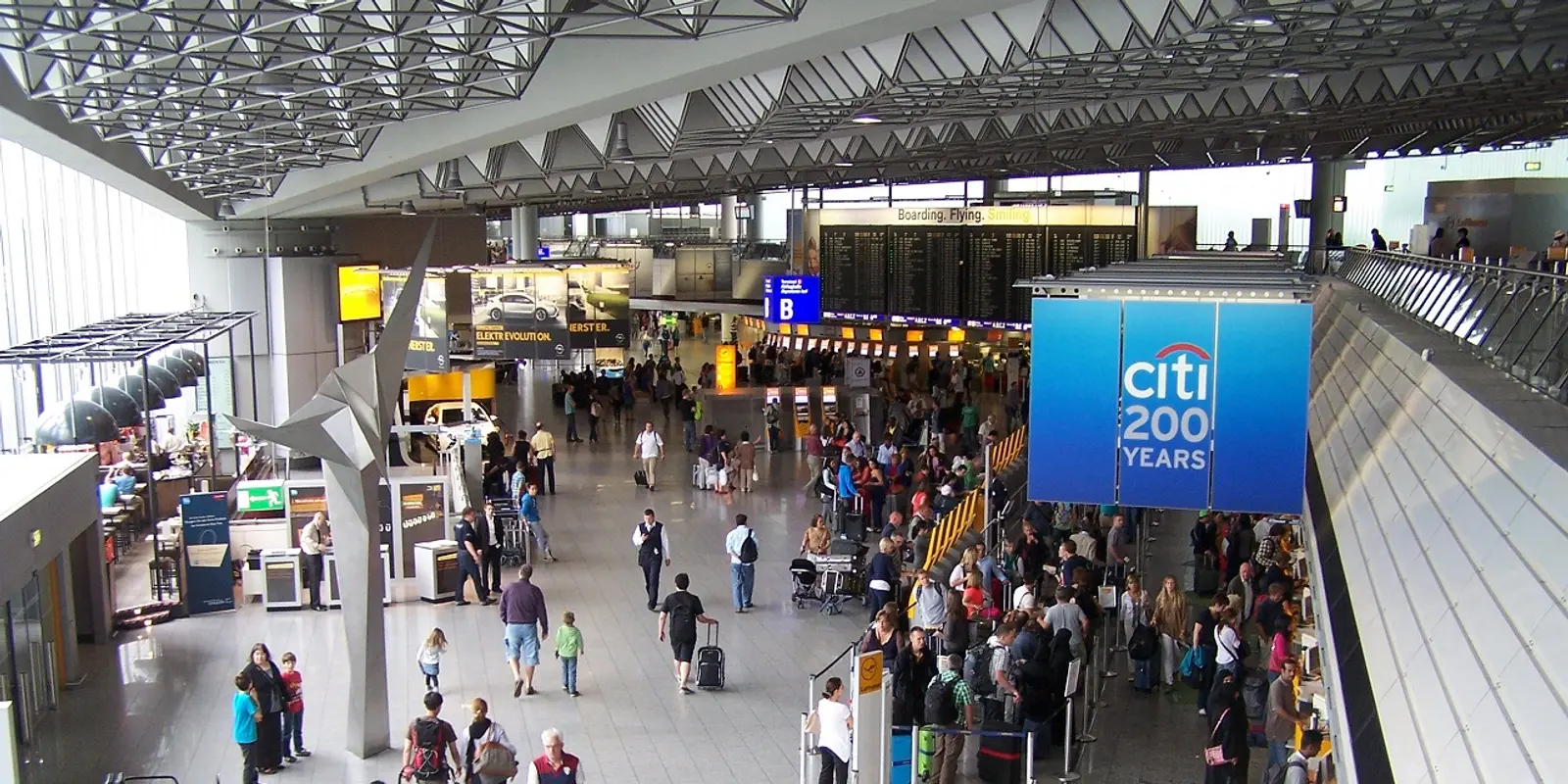 Free airport Wi-Fi is useful inside the terminal, while mobile data continues beyond it Passengers using phones inside Frankfurt Airport