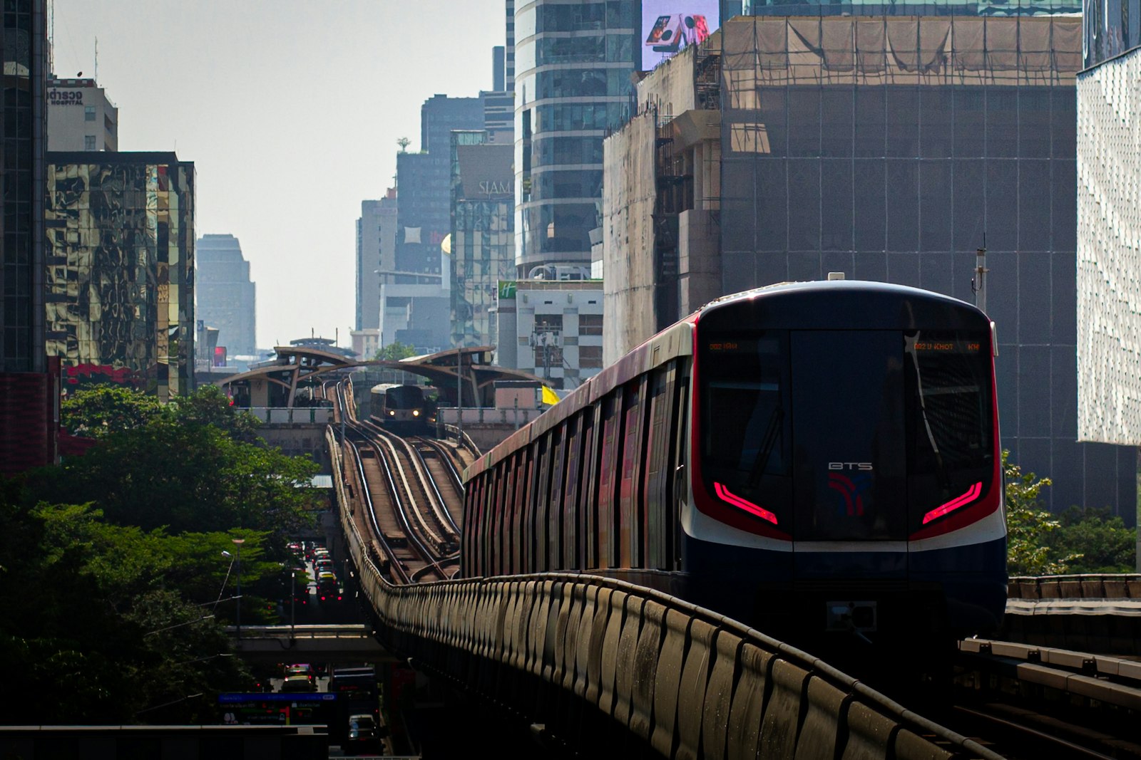 A BTS Skytrain running between Bangkok high-rises
