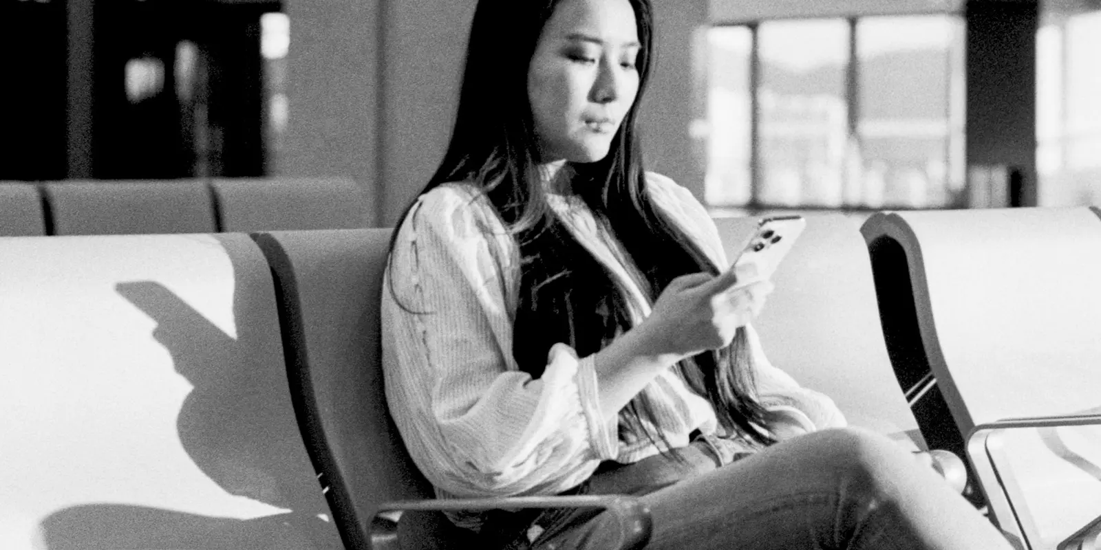 Matching data needs to trip length starts with knowing what actually consumes a gigabyte A traveler checking her smartphone while waiting in a bright airport terminal