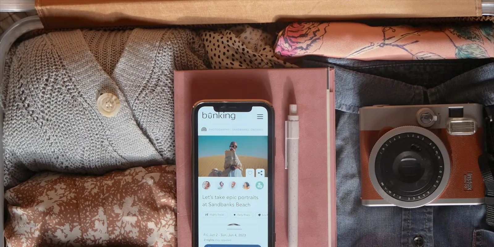 Installing your eSIM while you pack, on home Wi-Fi, is the safest time to do it An open suitcase packed for a trip with a phone resting among the travel essentials