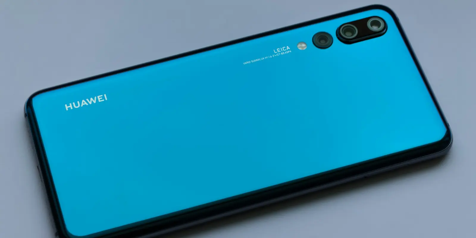 Close-up of a Huawei smartphone showing its rear camera and logo