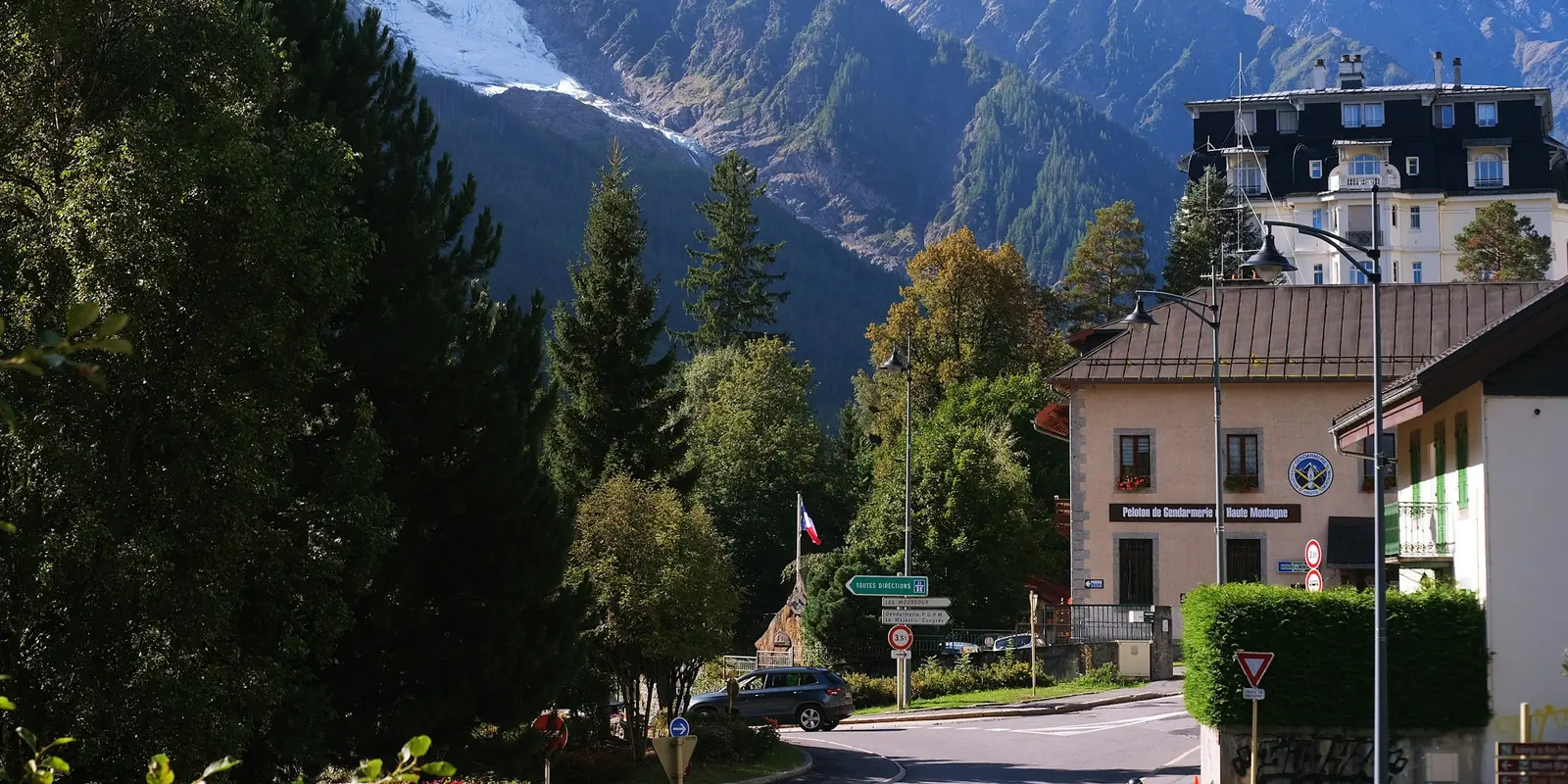 A street in a French Alpine village with mountains in the background
