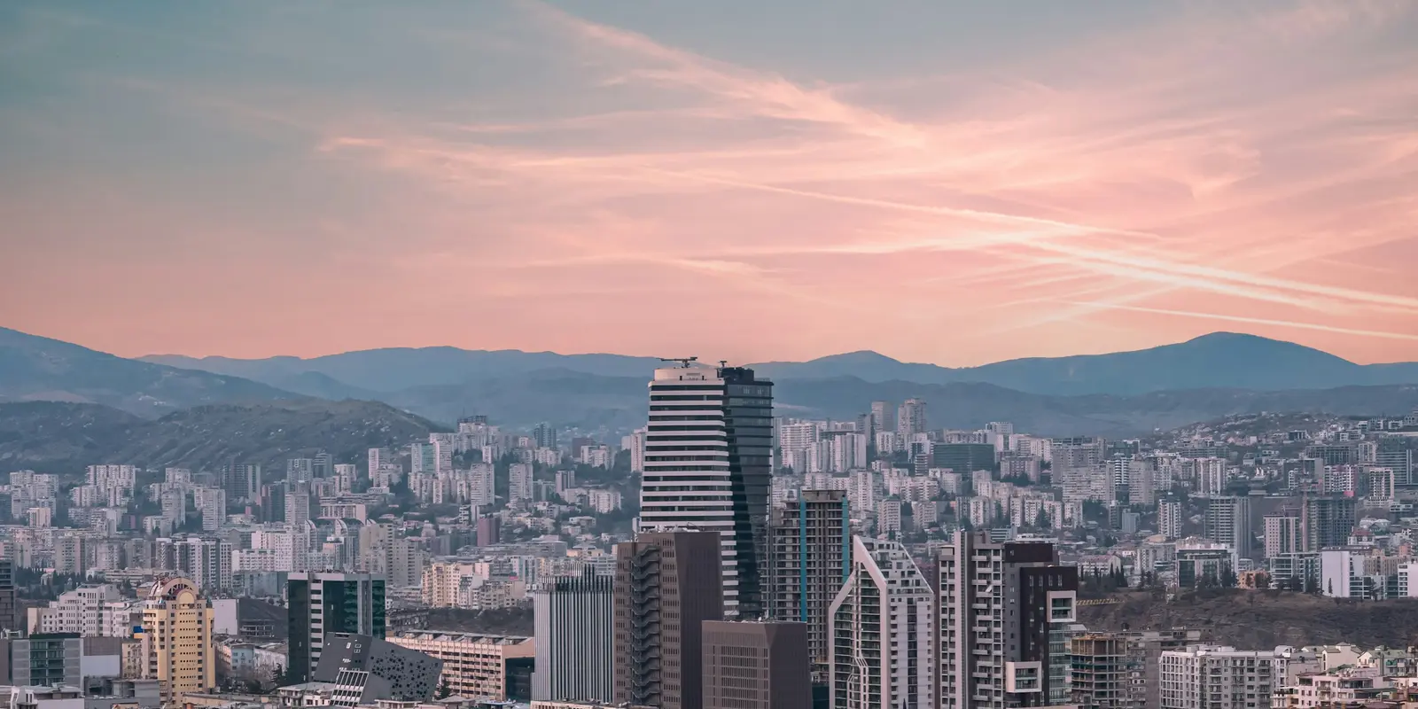 A view of Tbilisi's cityscape with mountains in the background, the kind of setting where Georgia's coworking and remote-work scene has grown around fiber-connected neighborhoods like Vake and Saburtalo