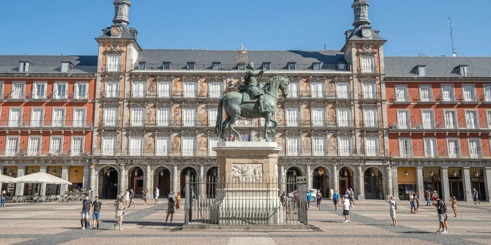 Plaza Mayor in Madrid, Spain, with the equestrian statue of Philip III and crowds of visitors