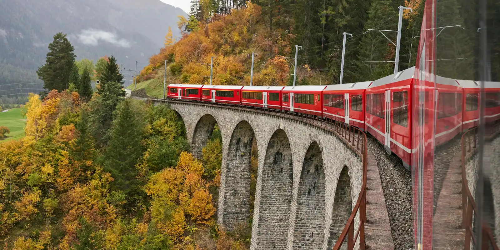 The Rhaetian Railway's Albula line: strong cellular signal along the route, but no onboard Wi-Fi A red train on the Albula line winds through the Swiss Alps in Graubünden