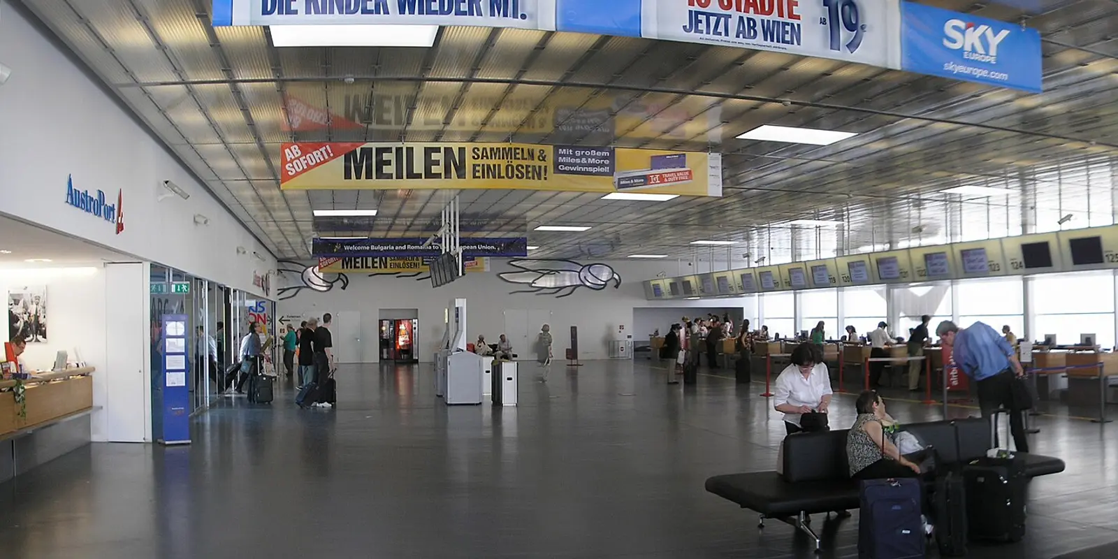 Passengers using the free airport Wi-Fi in a Vienna Airport terminal